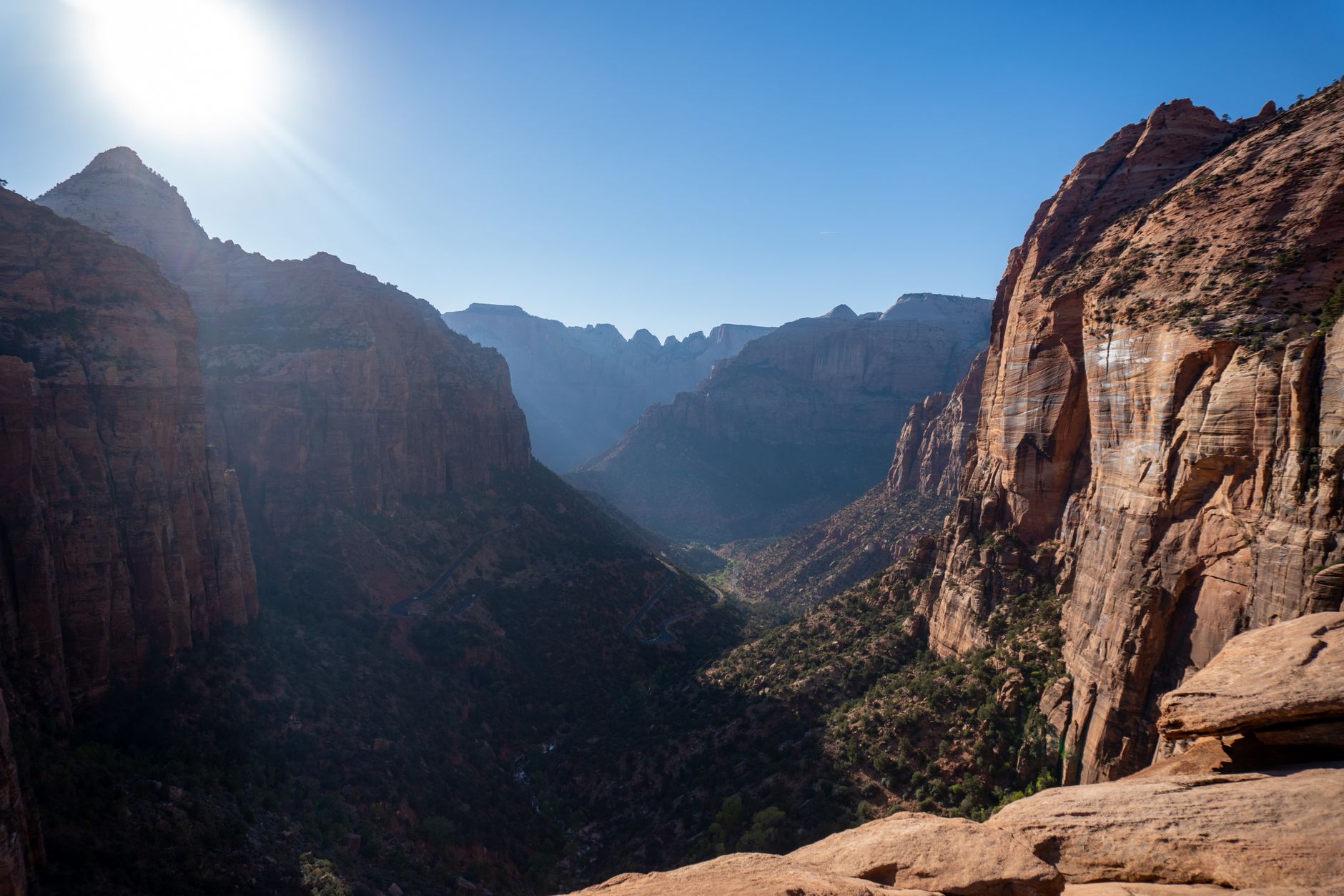 Ancient desert canyon with sun flare